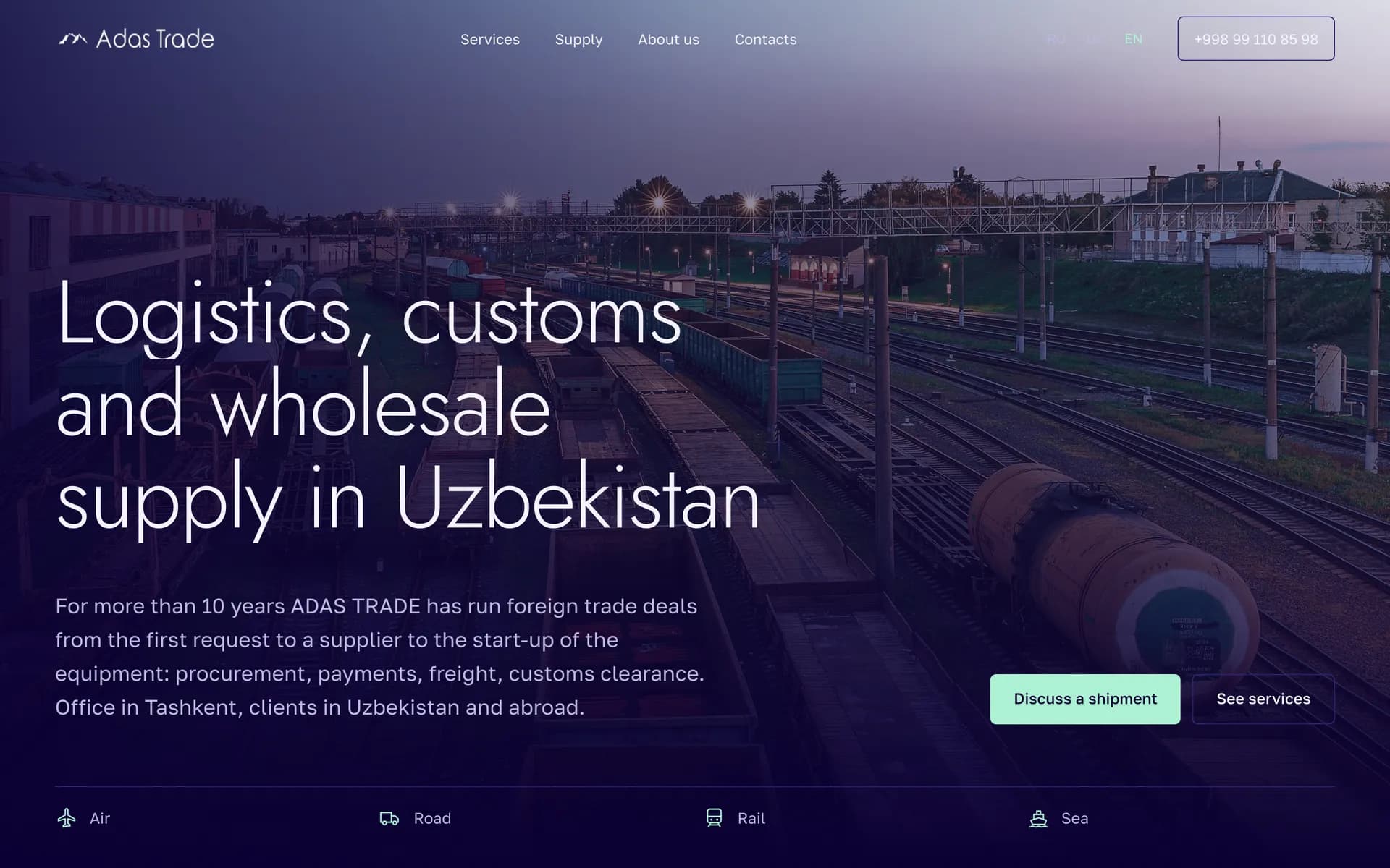The home page of adas-trade.uz: “Logistics, customs and wholesale supply in Uzbekistan” over a rail yard at dusk